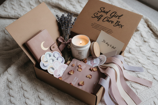 Self-care comfort box filled with candles, journals, crystals, calming decor, tea, and emotional wellness items for stress relief and difficult life moments.